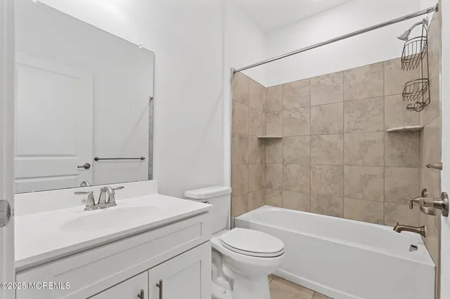 a bathroom with a sink a toilet and bathtub