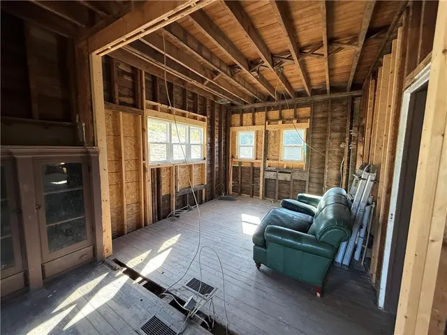 a view of an empty room with a fireplace and a window