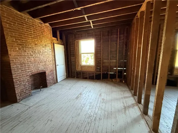 a living room with wooden floors and furniture