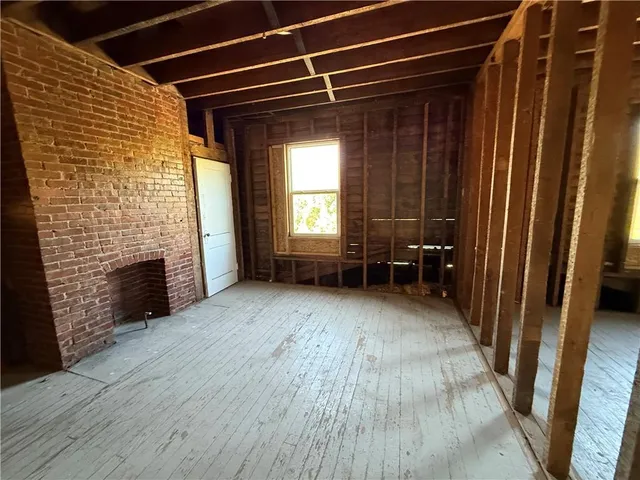 a living room with wooden floors and furniture