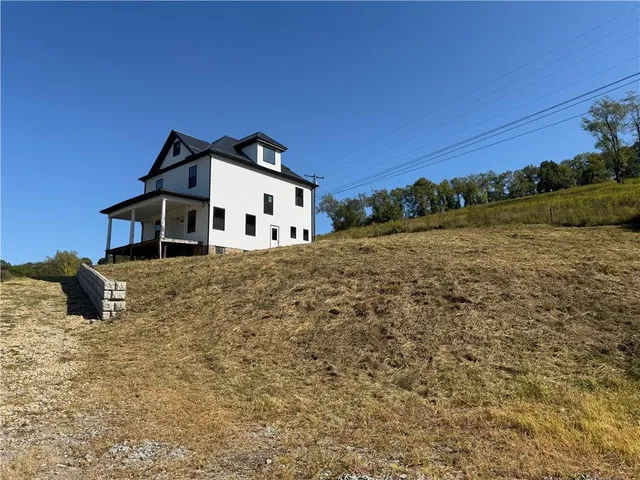 a house with trees in the background