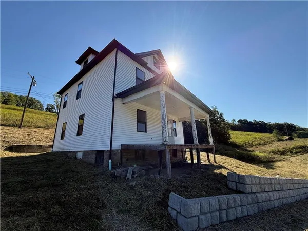 a view of a house with backyard and lake view