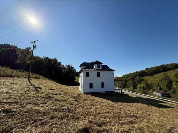 a view of a house with a snow in the background