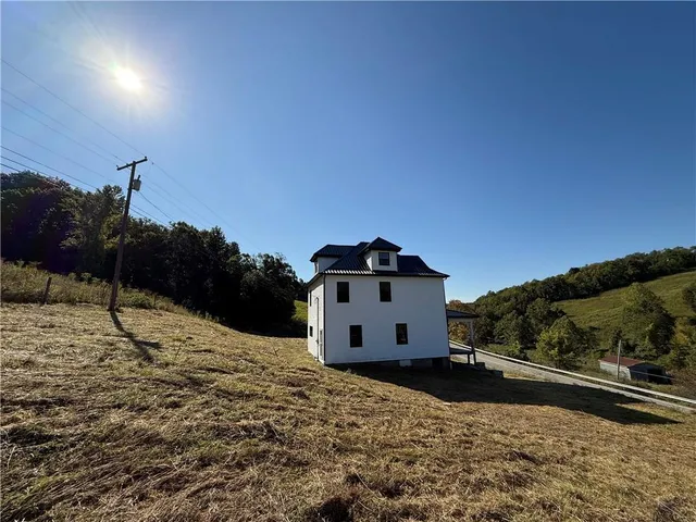 a view of a house with a snow in the background
