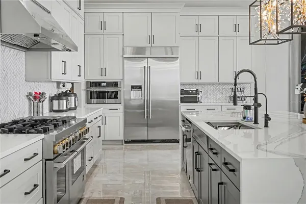 a kitchen with granite countertop a sink stove and cabinets