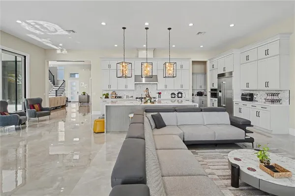 a living room with furniture and kitchen view