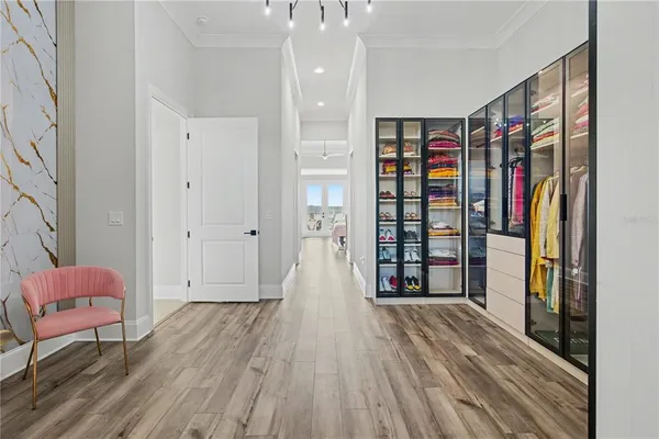 a view of walk in closet with clothes and shoes