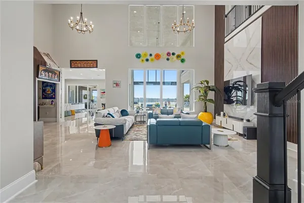 a living room with furniture gym equipment and a chandelier