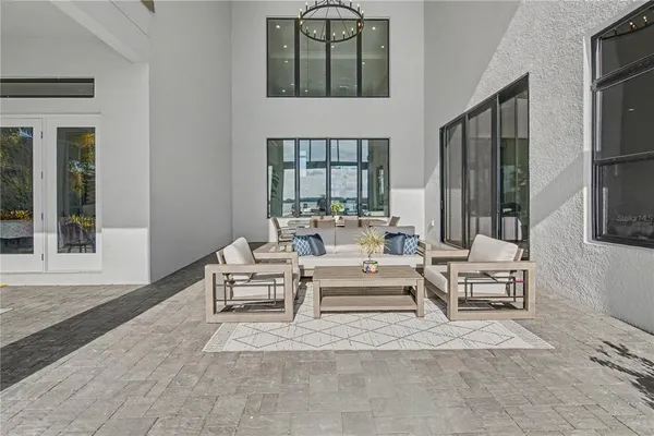 a living room with patio furniture and a garden