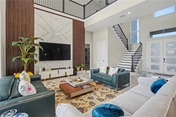 a living room with furniture and a wooden floor