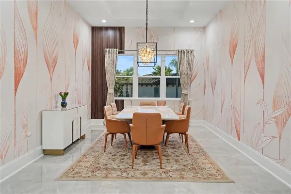 a dining room with furniture a rug and wooden floor