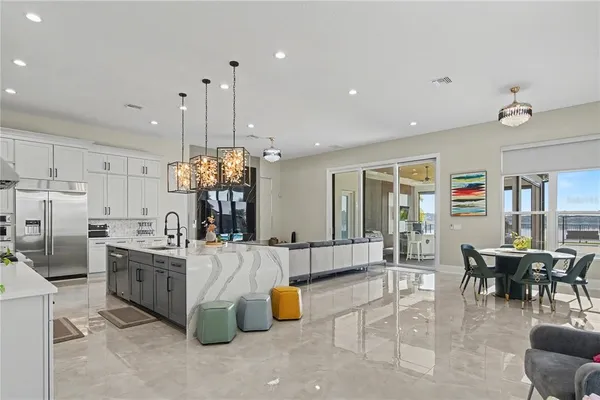 a living room with furniture and kitchen view