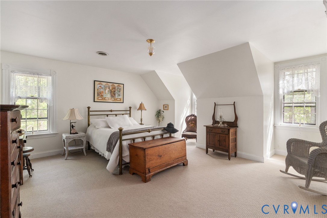 7381 McClellan Road Mechanicsville, VA 23111 - Photo 53 of 66 a spacious bedroom with a bed and a couch
