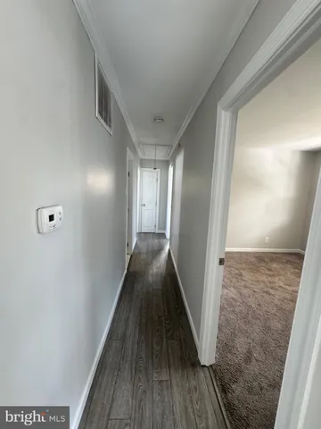 a view of hallway with wooden floor