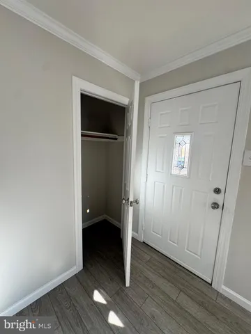 an empty room with wooden floor and closet
