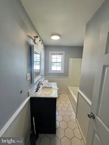 a bathroom with a sink toilet and mirror
