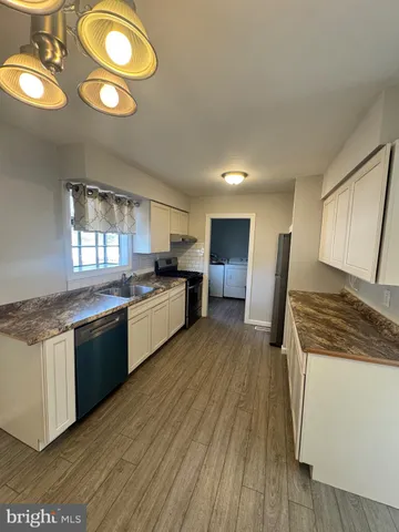 a kitchen with stainless steel appliances granite countertop a stove and cabinets