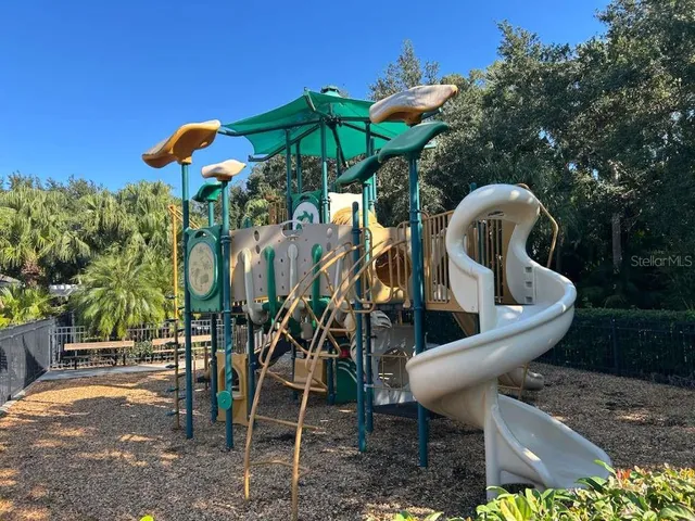 a view of a chairs and table in backyard