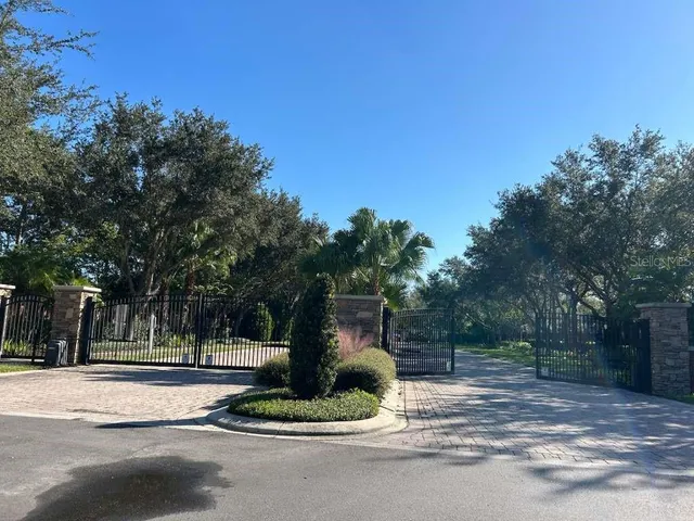 a front view of a house with a yard and tree s
