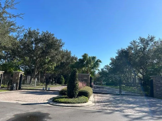 a front view of a house with a yard and tree s