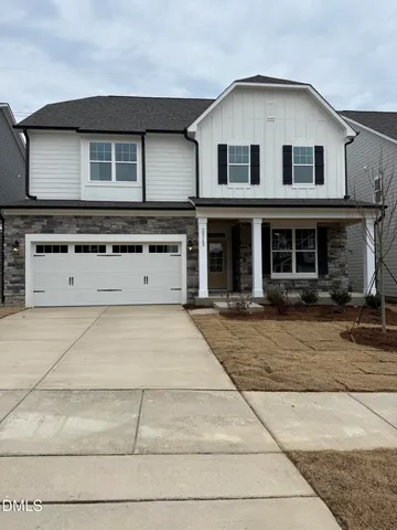 a view of a white house with large windows