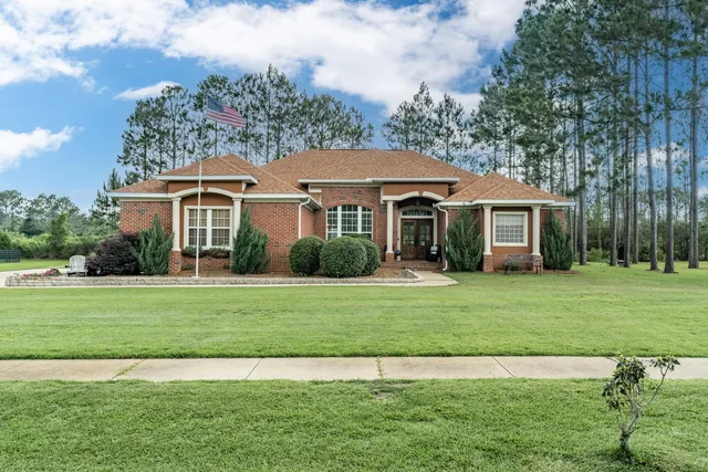 a front view of a house with a garden