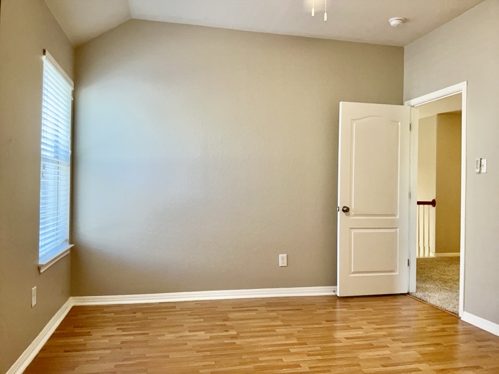 2518 Vestavia Ridge Lane Cedar Park, TX 78613 - Photo 13 of 23 Bedroom with light wood-style floors and vaulted ceiling