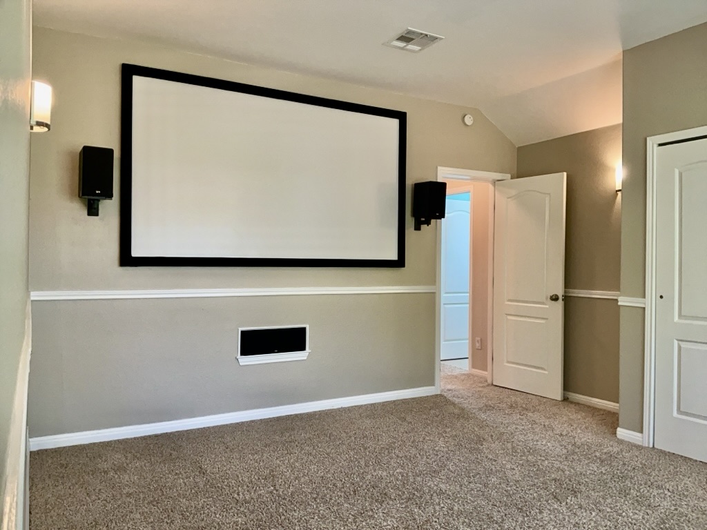 2518 Vestavia Ridge Lane Cedar Park, TX 78613 - Photo 18 of 23 Carpeted cinema featuring baseboards and vaulted ceiling