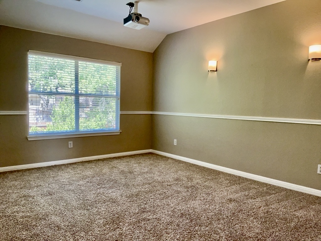 2518 Vestavia Ridge Lane Cedar Park, TX 78613 - Photo 19 of 23 Carpeted spare room featuring lofted ceiling and baseboards