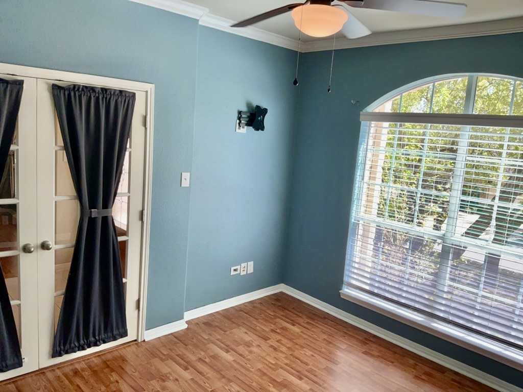 2518 Vestavia Ridge Lane Cedar Park, TX 78613 - Photo 21 of 23 Empty room with a ceiling fan, ornamental molding, light wood-style flooring, and french doors