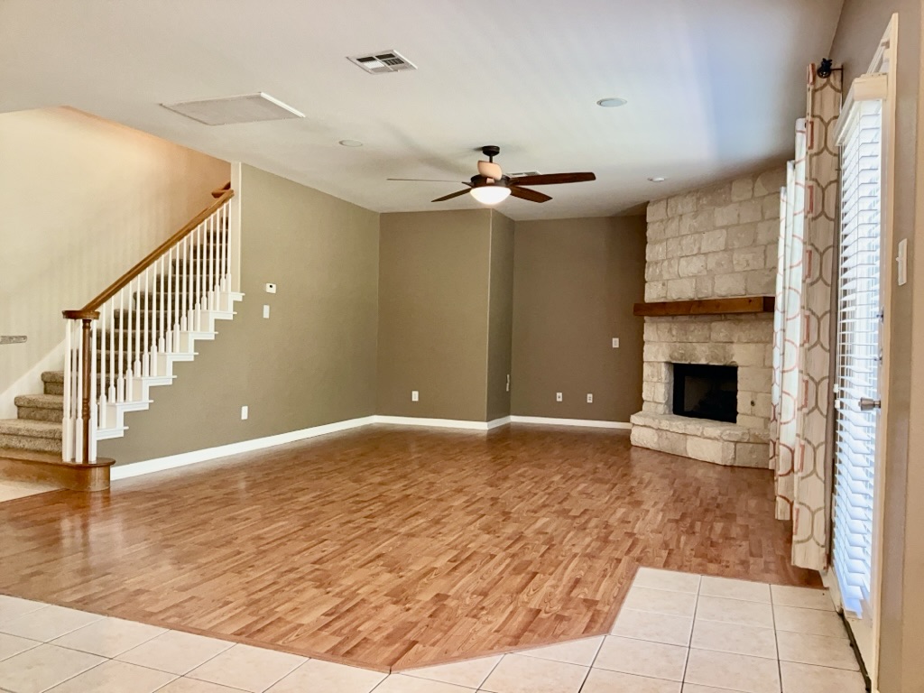 2518 Vestavia Ridge Lane Cedar Park, TX 78613 - Photo 3 of 23 living room with light wood finished floors, ceiling fan, and a fireplace