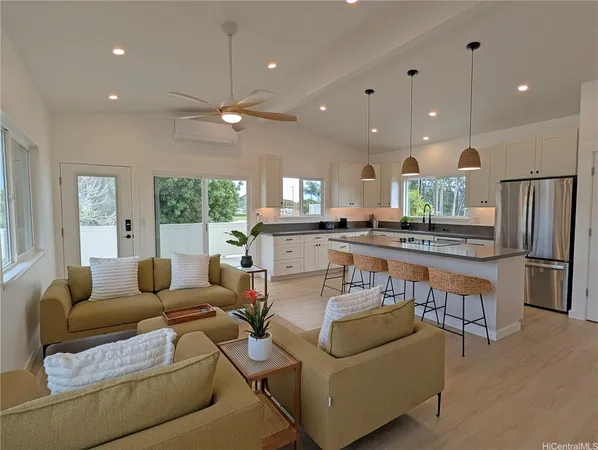 a living room with furniture and kitchen view