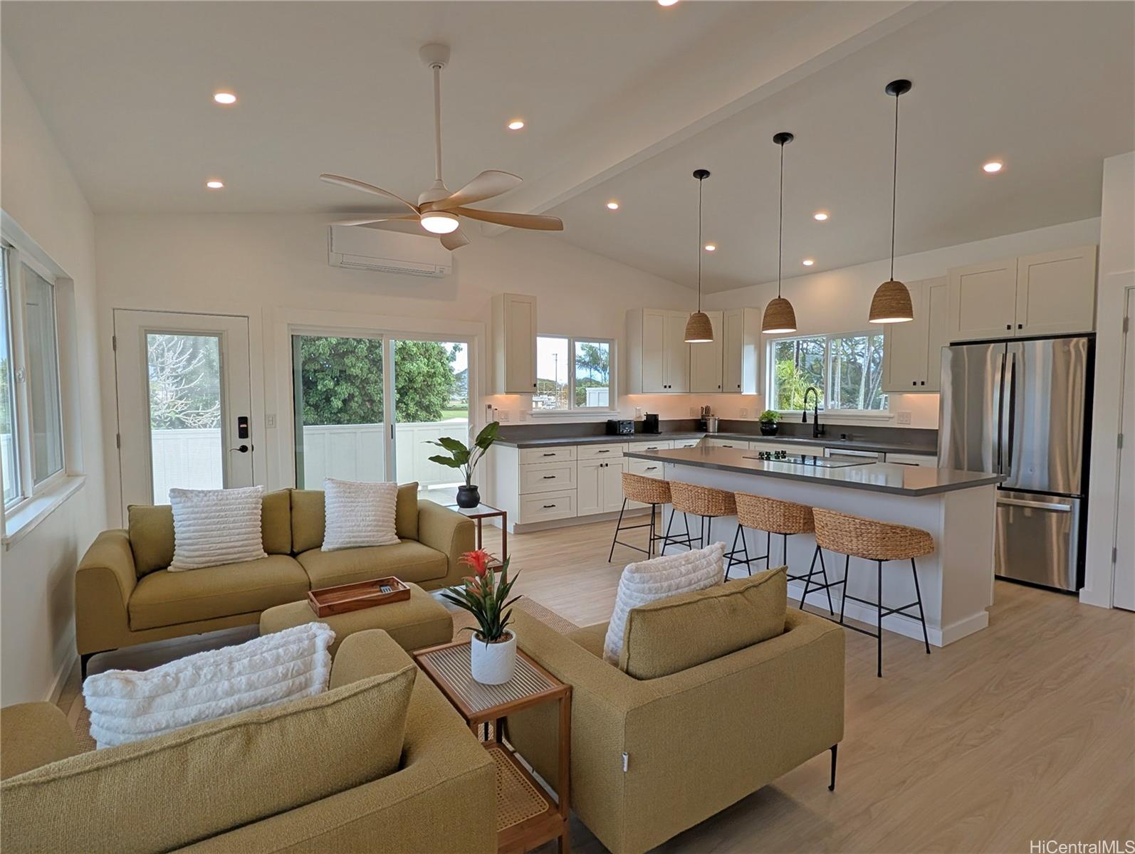 a living room with furniture and kitchen view