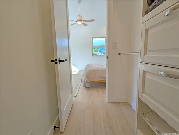 a view of bedroom with a bed and wooden floor