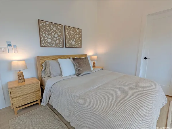 a bedroom with a bed and a lamp on table