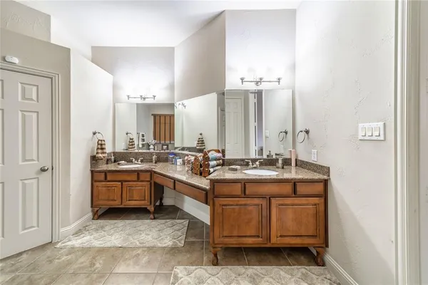 a view of a kitchen with stainless steel appliances granite countertop a stove and cabinets