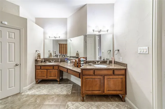 a view of a kitchen with stainless steel appliances granite countertop a stove and cabinets