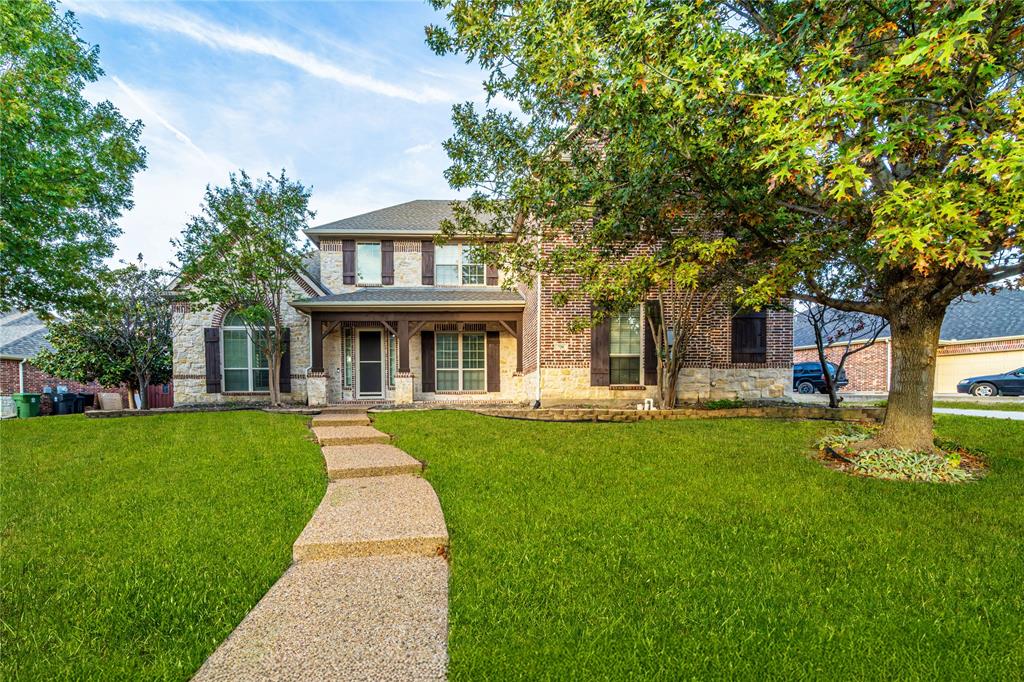 720 Nighthawk Drive Murphy, TX 75094 - Photo 2 of 40 a front view of a house with garden