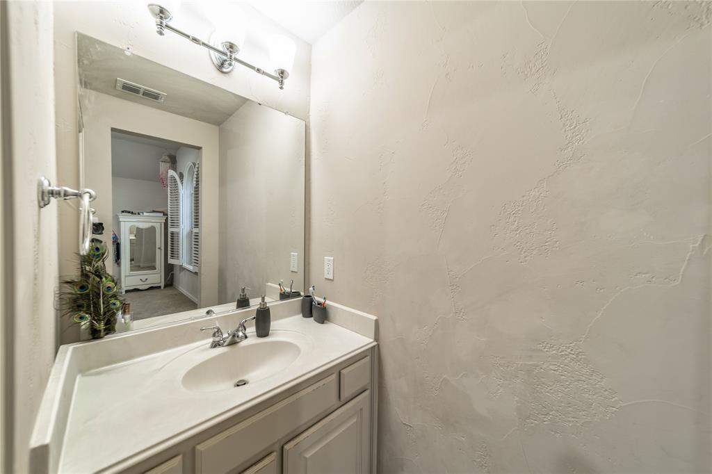 720 Nighthawk Drive Murphy, TX 75094 - Photo 27 of 40 a bathroom with a sink and a mirror