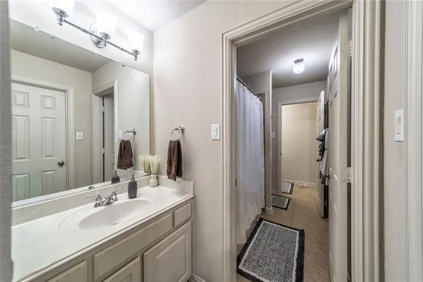 a en suite bathroom with a double vanity sink a mirror and a shower