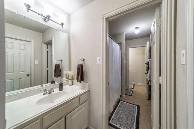 a en suite bathroom with a double vanity sink a mirror and a shower