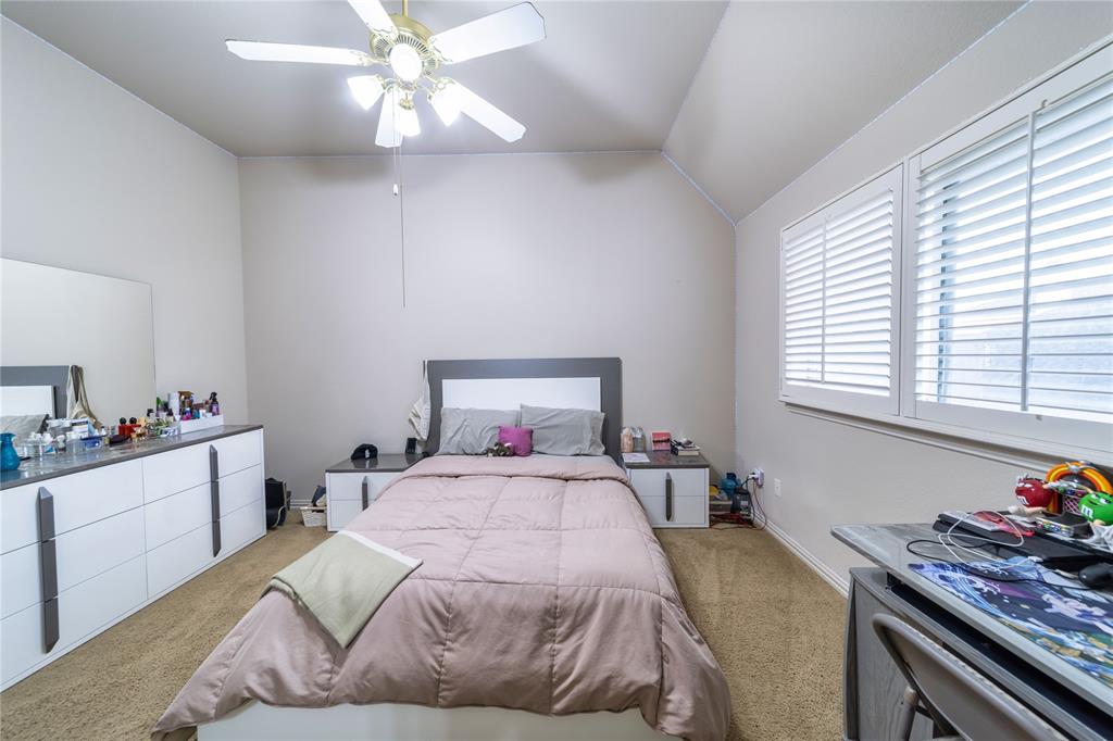 720 Nighthawk Drive Murphy, TX 75094 - Photo 30 of 40 a bedroom with a bed and a chandelier