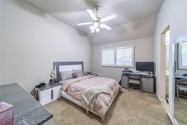 a bedroom with a bed couch and window