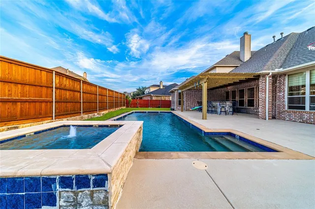 a view of swimming pool with outdoor seating