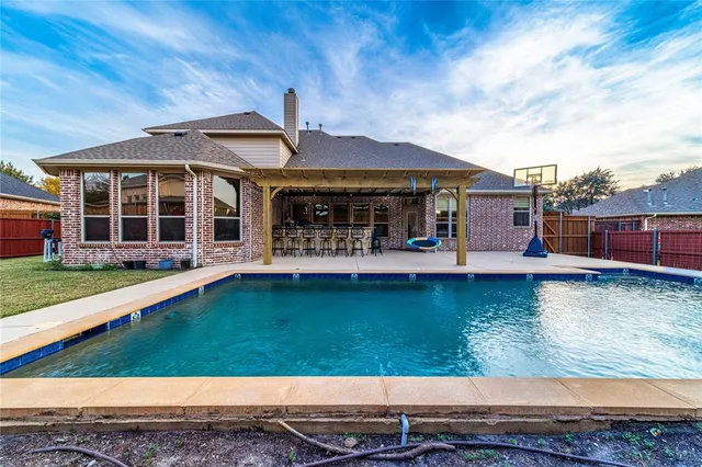 swimming pool view with a seating space