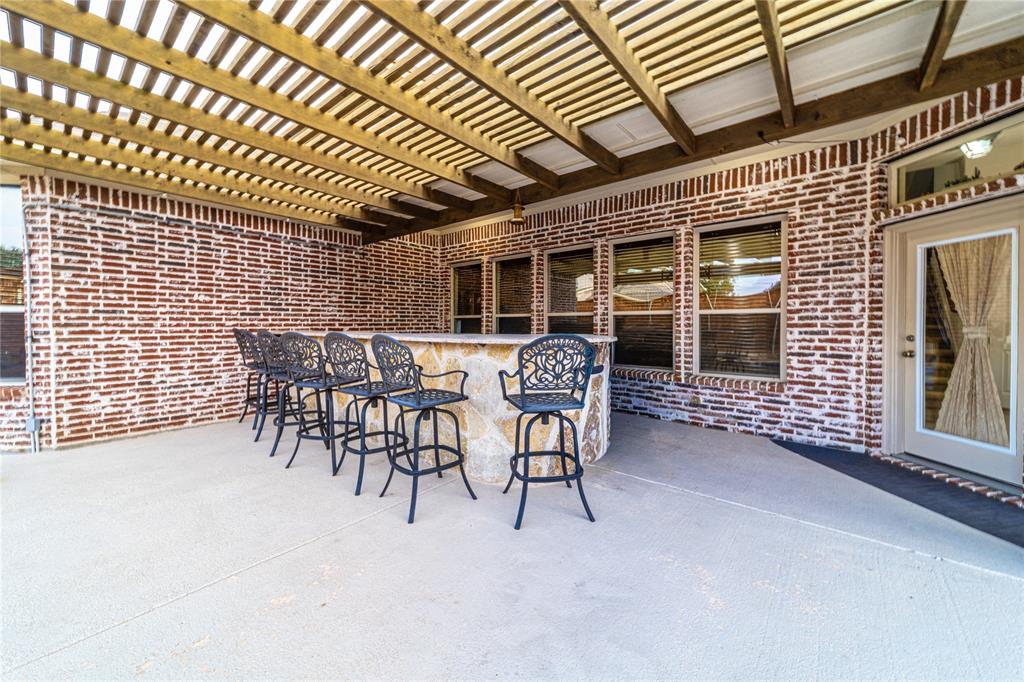 720 Nighthawk Drive Murphy, TX 75094 - Photo 38 of 40 a patio with table and chairs