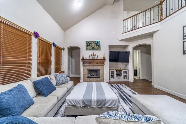 a living room with furniture fireplace and flat screen tv