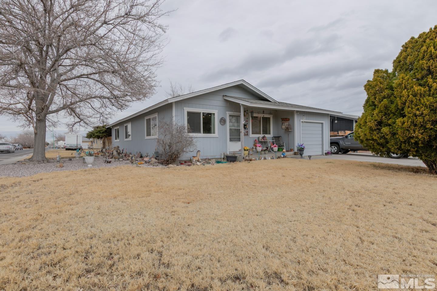 1080 Lee Fallon, NV 89406 - Photo 1 of 23 a front view of house with yard and trees in the background