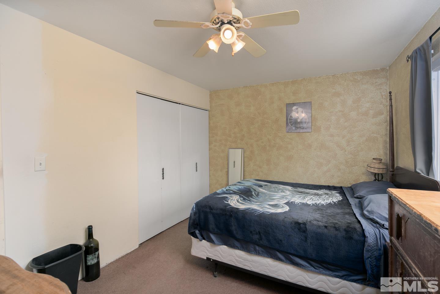 1080 Lee Fallon, NV 89406 - Photo 15 of 23 a bedroom with a bed and a chandelier