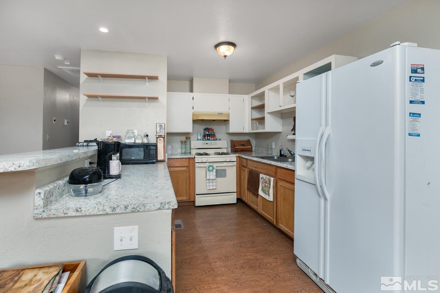 1080 Lee Fallon, NV 89406 - Photo 8 of 23 a kitchen with stainless steel appliances granite countertop a refrigerator a stove and a sink